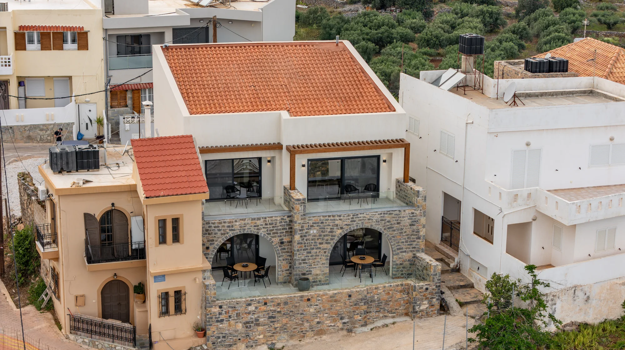 Aerial view of the complete AEOS Elounda four-residence property